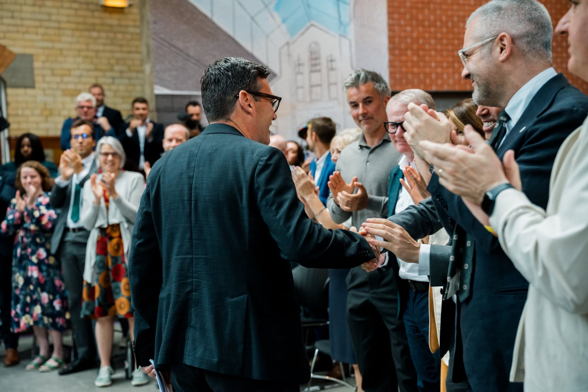 Andy Burnham shakes hands with supporters