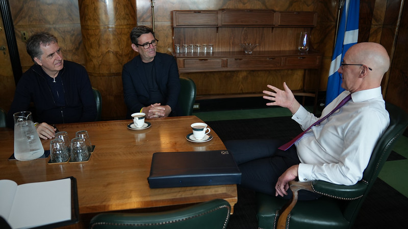 John Swinney sits at a table with Andy Burnham and Steve Rotherham